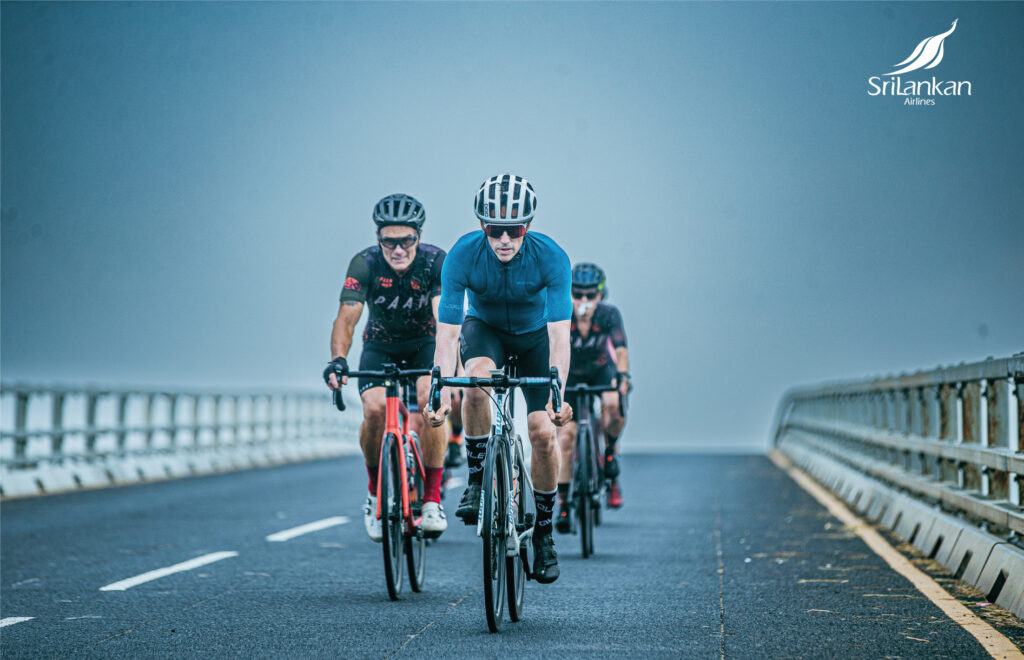 Cyclists crossing Sangupiddy bridge in Northern Sri Lanka